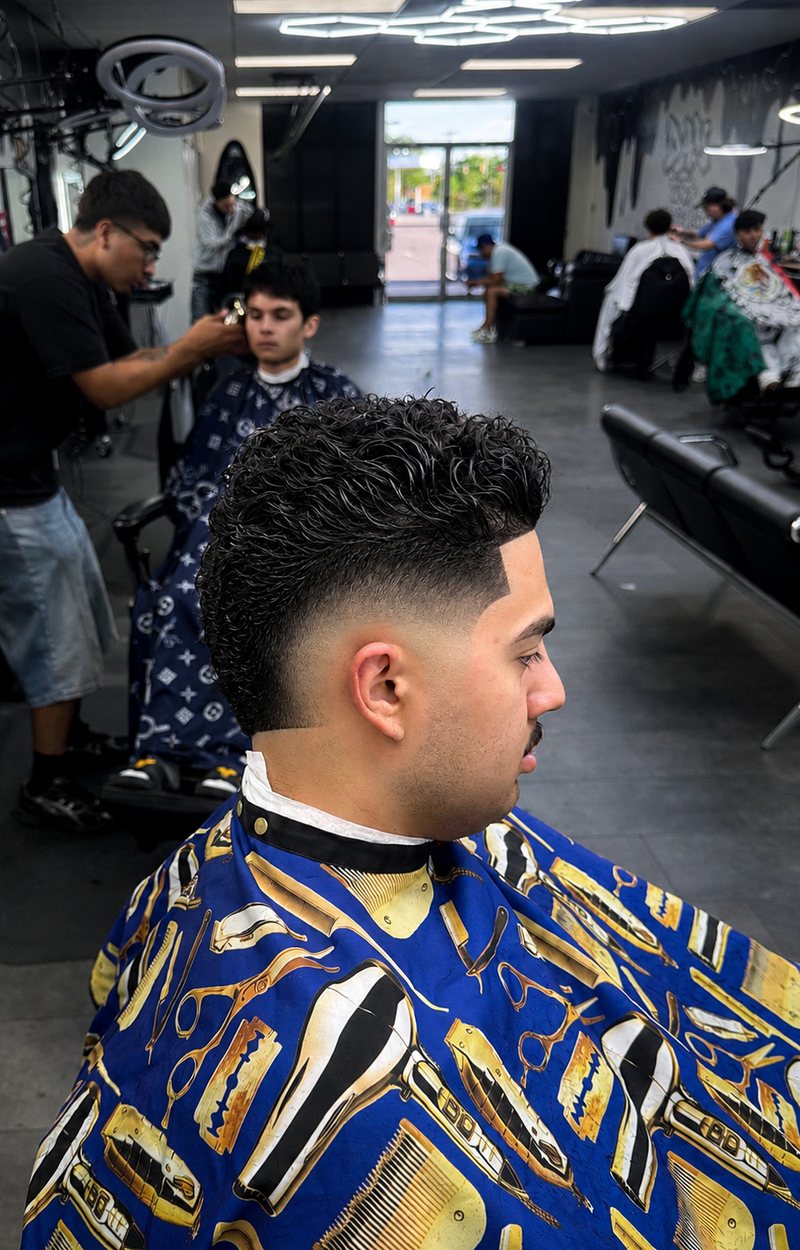 A finished curly top and skin fade, fresh out of the chair