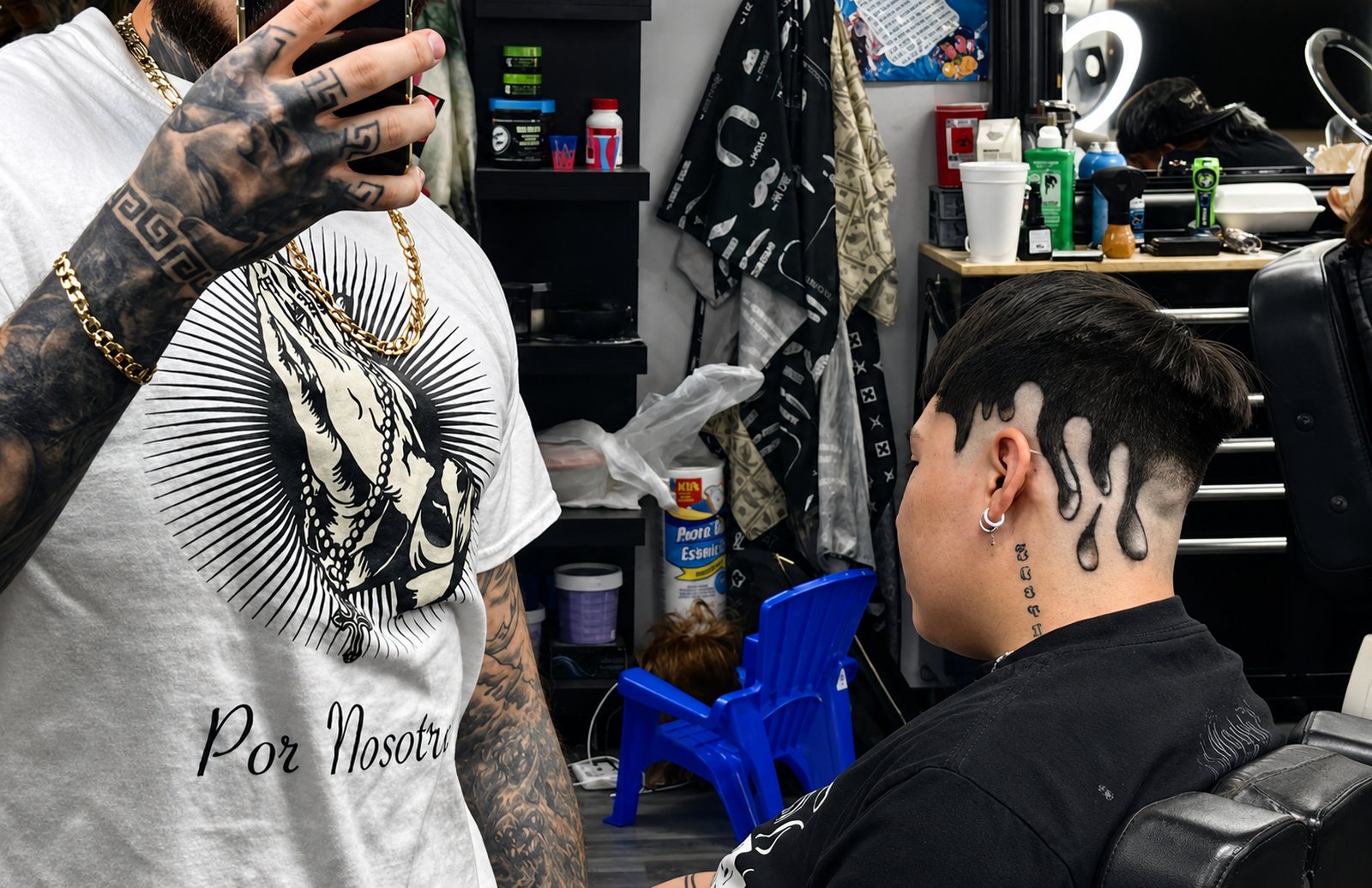 A freehand paint-drip design cut into a client's hairline at Dam This Barbershop
